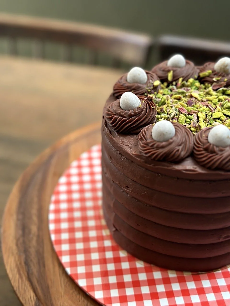 Dark chocolate piped rosette pistachio cake Cambridge bakery